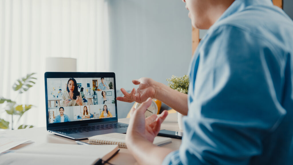 Young Asia businessman using laptop talk to colleagues about plan in video call meeting