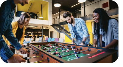 Company employees playing foosball